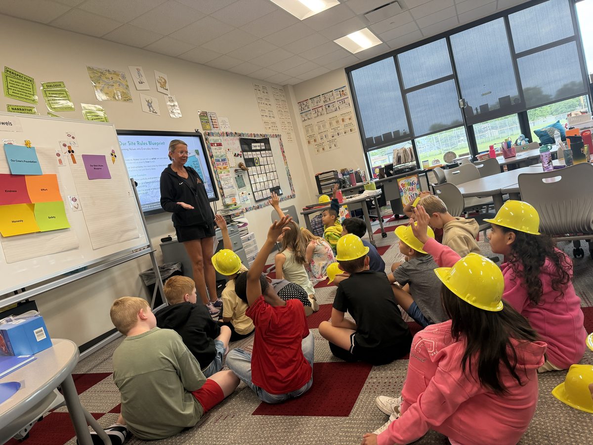 Elementary students in hard hats building their classroom's 'Site Rules Blueprint' during a GRiT lesson