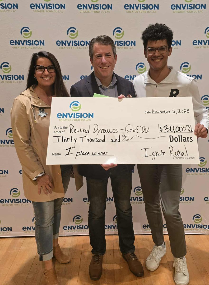 Rewired Dynamics and GRiTedu accepting a $30,000 first-place check